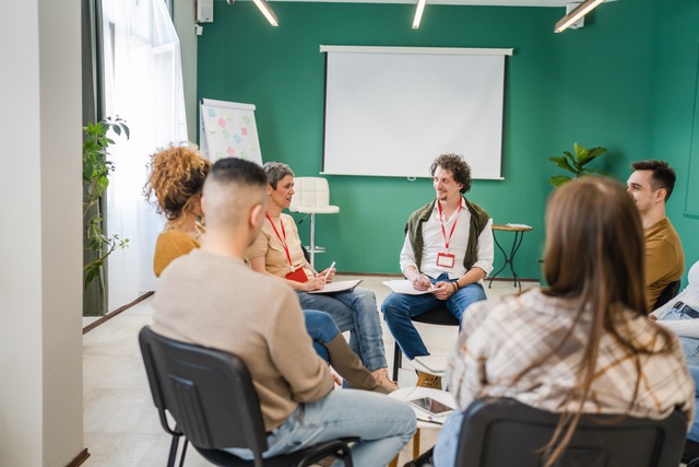 adults sitting in chairs in a circle at a group adult DBT therapy session with talking circles