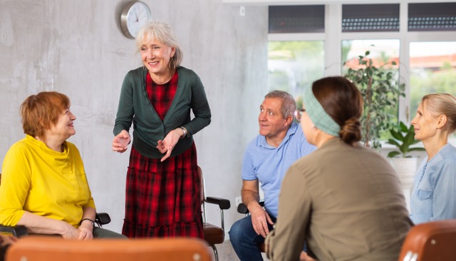 senior citizens sitting in a group session with talking circles therapy